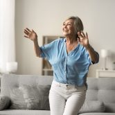 Older adult woman performs the Timed Up and Go (TUG) Test to assess mobility, balance, and fall risk, demonstrating a functional movement assessment used by physical therapists.
