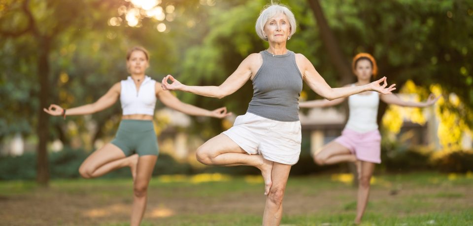 Single Leg Stance Test for Balance | Movement Is Freedom Physical Therapy Older woman demonstrates single leg balance while standing on one leg, illustrating the Single Leg Stance Test used to assess balance, stability, and fall risk in older adults.